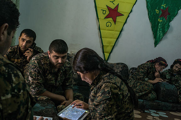 To follow a story on YPG fighters striking ISIS position by Rukmini Callimachi - Hasaka, Syria - July 31, 2015: YPG fighters check maps and location as they coordinate one air strike on ISIS position inside Hasaka, at a YPG headquarters on the outskirts of Hasaka. CREDIT: Photo by Mauricio Lima for The New York Times                              NYTCREDIT: Mauricio Lima for The New York Times