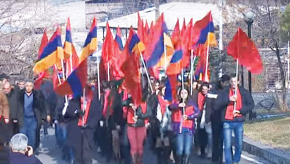 ARF members carrying the tri-color and ARF flag enter Yerablur;