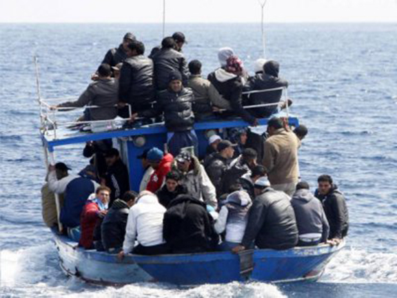 Refugees aboard a boat making their way to Europe. (Source: New.am)