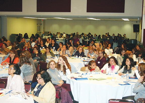 Educators listen attentively to the opening session of the conference