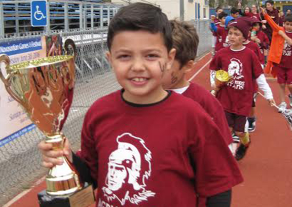 AGBU Manoogian-Demirjian student proudly holding the team trophy.