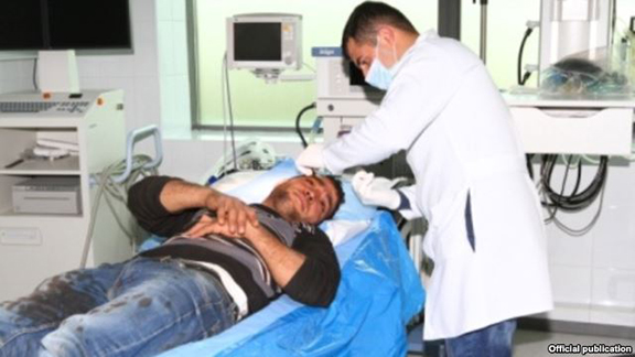 Yevand Firian, a Karabakh farmer, receives medical treatment after being wounded in Azerbaijani rocket fire.