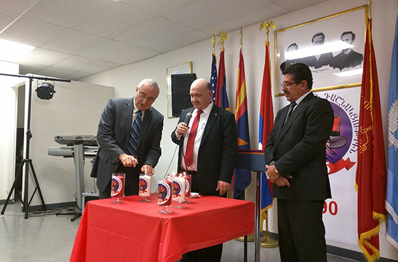 Hovan Demirjian and Vatche Megerditchian lighting candles in recognition of their over 40 years of commitment to the A.R.F.;