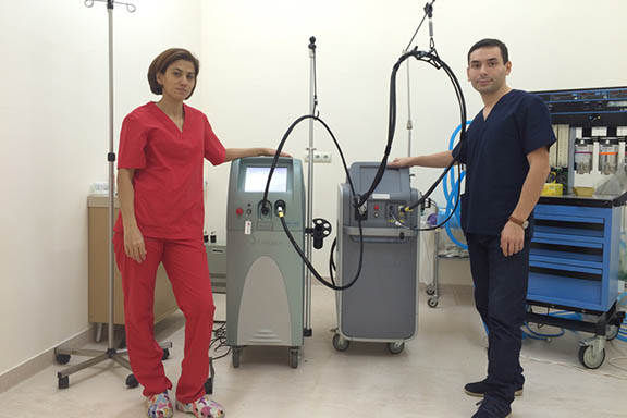 Dr. Hrachya Arshakyan and Dr. Alina Arshakyan, both plastic surgeons at Arabkir Pediatric Hospital are standing next to the two lasers (the GentleMax and the AlexTriVantage lasers) donated by Candela-Syneron laser company to Armenia.