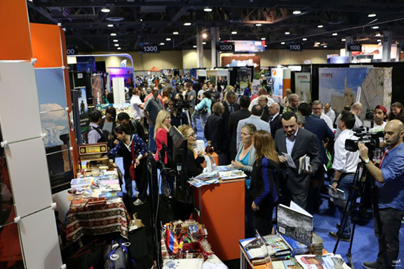 Image of people walking around the LA Travel and Adventure Show and visiting the Armenia booth. (Source: Public Radio of Armenia)