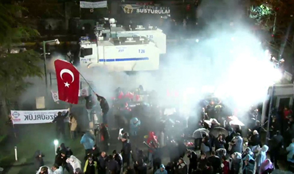 The Turkish police raiding the Zaman headquarters and pepper spraying those who were standing outside it. (Source: Today's Zaman)