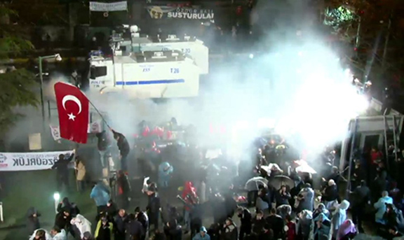 Turkish police raiding crowds outside Zaman Headquarters and spraying them with tear gas. (Source: Today's Zaman)