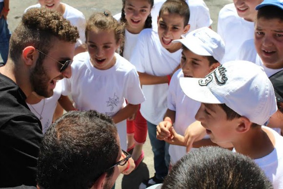 AYF Youth Corps 2016 participant, Hovig Zaki, with campers in Shushi, Artsakh.