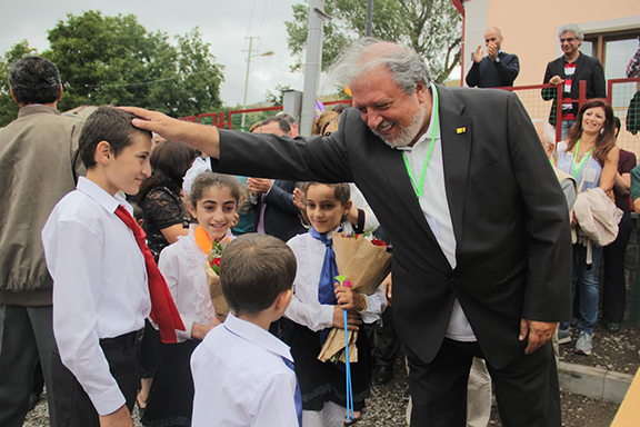 Stepan De-Bedrossian, the general manager of ARI, interacts with the children of Ariavan at the inauguration event