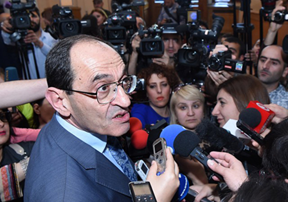 Armenia's Deputy Foreign Minister Shavarsh Kocharyan flanked by reporters