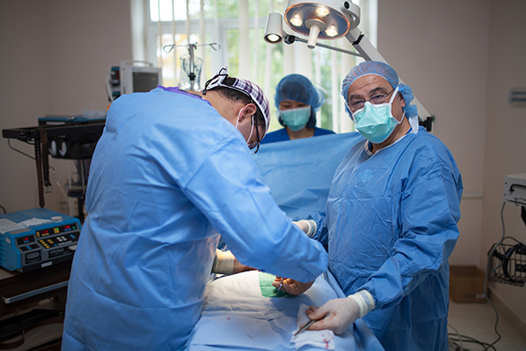 Medical staff performing surgery on patient