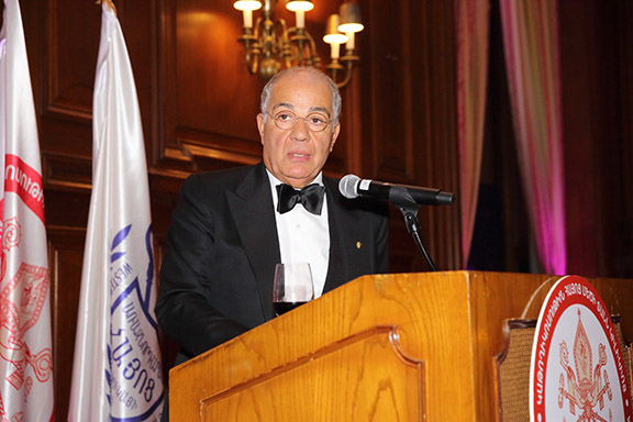 The banquet host Harry Nadjarian congratulates the Catholicos on his 20 years of service