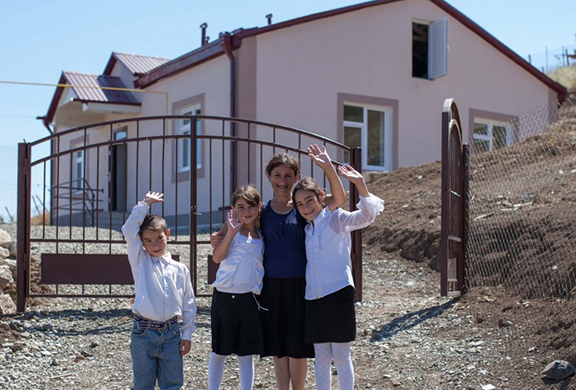 Artsakh family in their newly-built home (Photo: Hayastan All-Armenian Fund)