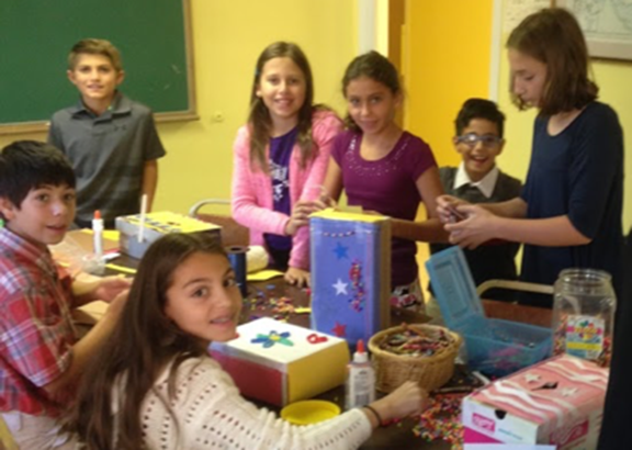 St. Mary’s Armenian Church grade 5-6 students making their donation boxes for their fundraiser. Clockwise from front: Rose Ariyan, Mihran Maldjian, Chris Stepanian, Azniv Basralian, Anna Hallajian, Armen Hallajian, Genevieve Zakian.