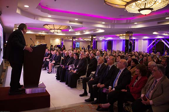 Museum Governing Board members, Mayor Devine, and Senator Portantino seated in first row listen to introduction of the Concept Design by Master of Ceremony Zaven Kazazian